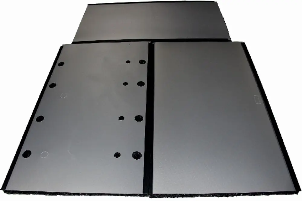 Verkleidung und Wärmedämmung in grauer Farbe, bestehend aus mehreren Platten mit Ausschnitten, für Wolf SPU-2-W-1500. Klar erkennbare Oberflächenstruktur und Montagebohrungen.
